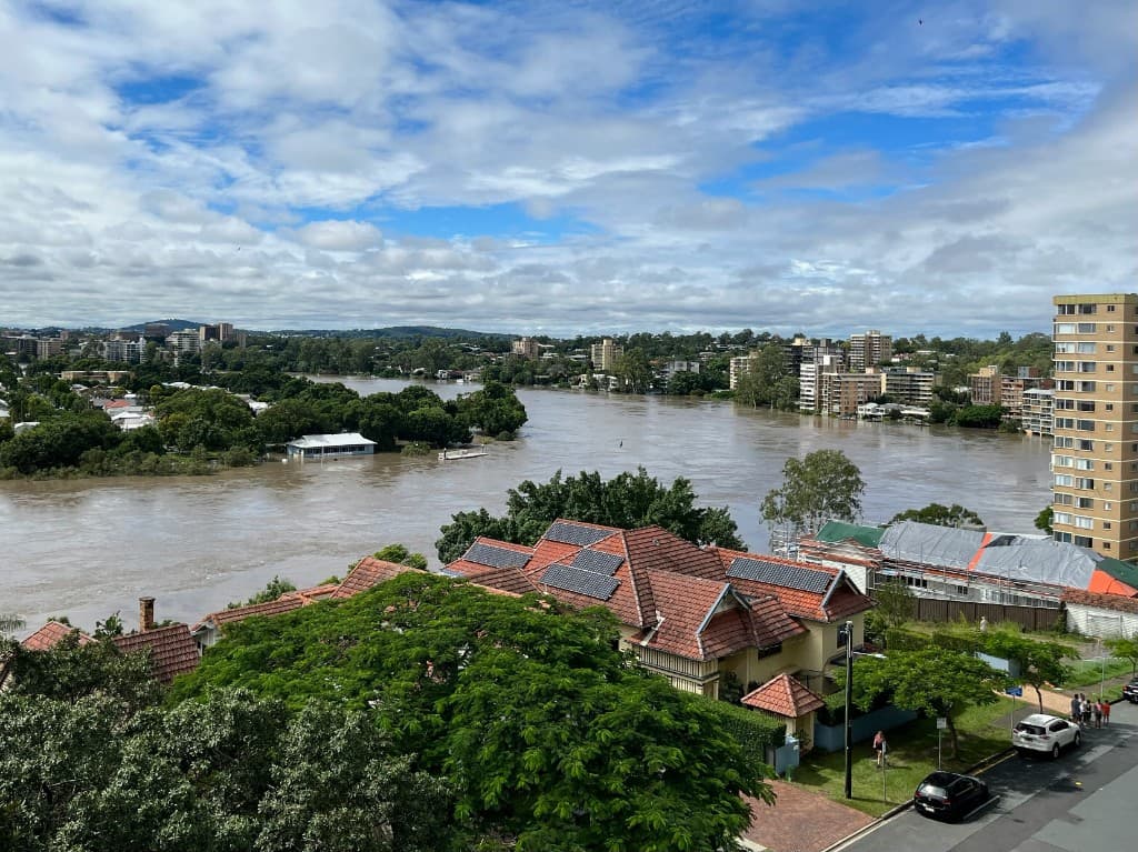 River floodwaters overflowing into a residential neighborhood